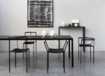 photograph of black chairs around dining table