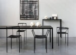 photograph of black chairs around dining table