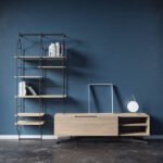 A unit with a wooden TV stand and standing steel shelf unit.